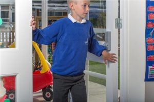 Image shows child with fingers in door and frame gap