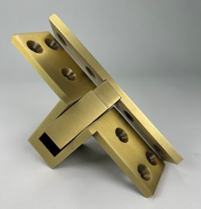 Picture of a semi concealed Harmon hinge is Satin Brass